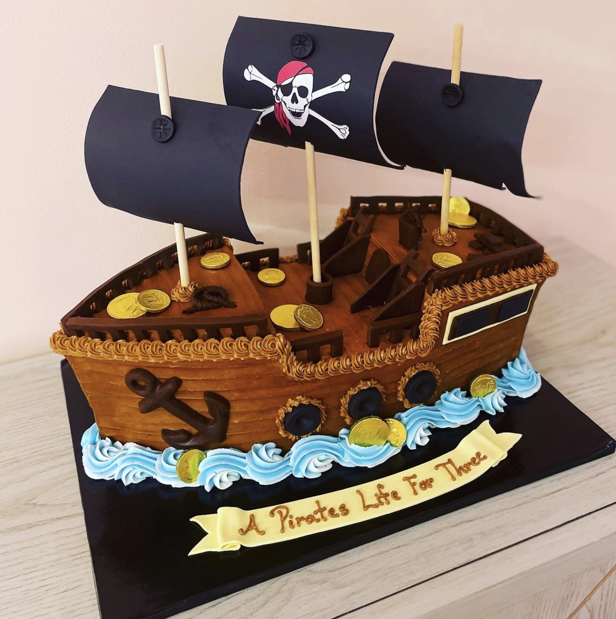 A sculpted pirate ship birthday cake made by a custom cake bakery in Indianapolis.