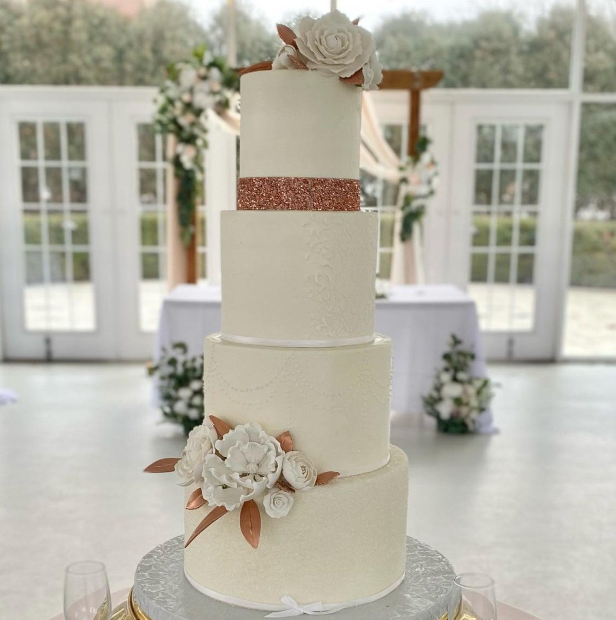 A five-tier white buttercream wedding cake by Sweet Escape Cake Company in Indianapolis.
