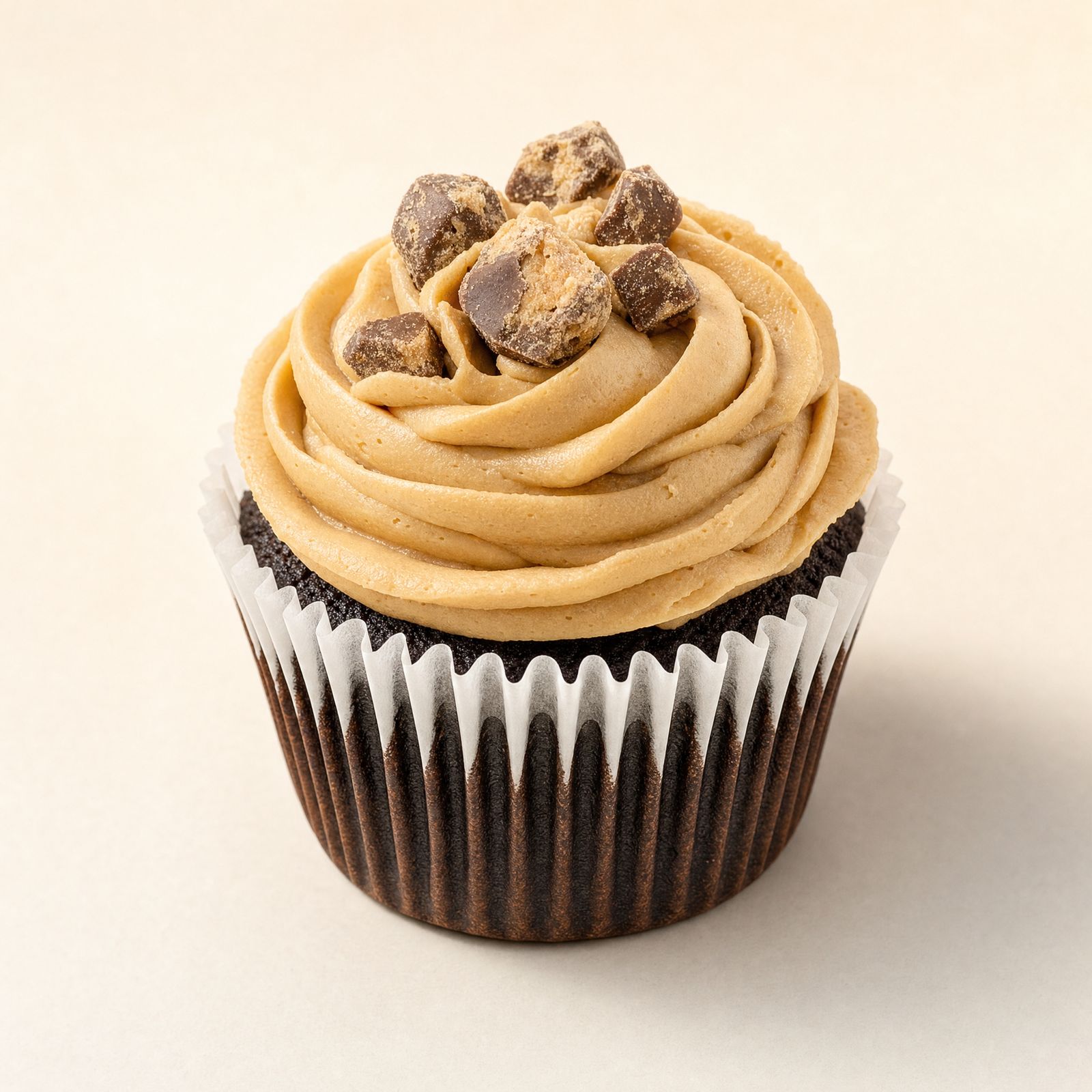 Cupcakes with caramel-toned buttercream and crunchy praline topping in the Butter Pecan style at Sweet Escape Cake Company in Indianapolis.