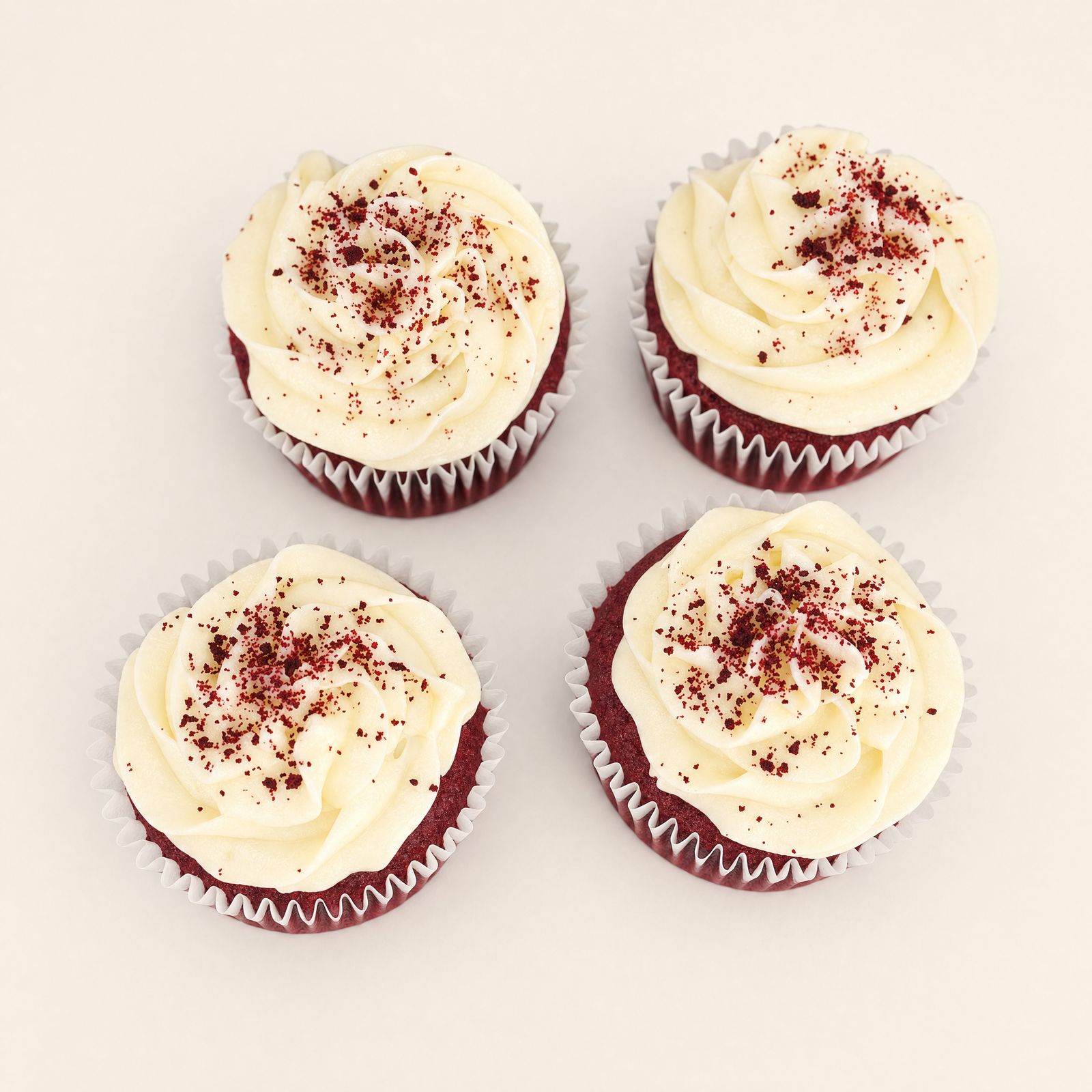 Red velvet cupcakes with white frosting and red crumb topping, one of the most popular cake flavors at Sweet Escape Cake Company in Indianapolis.