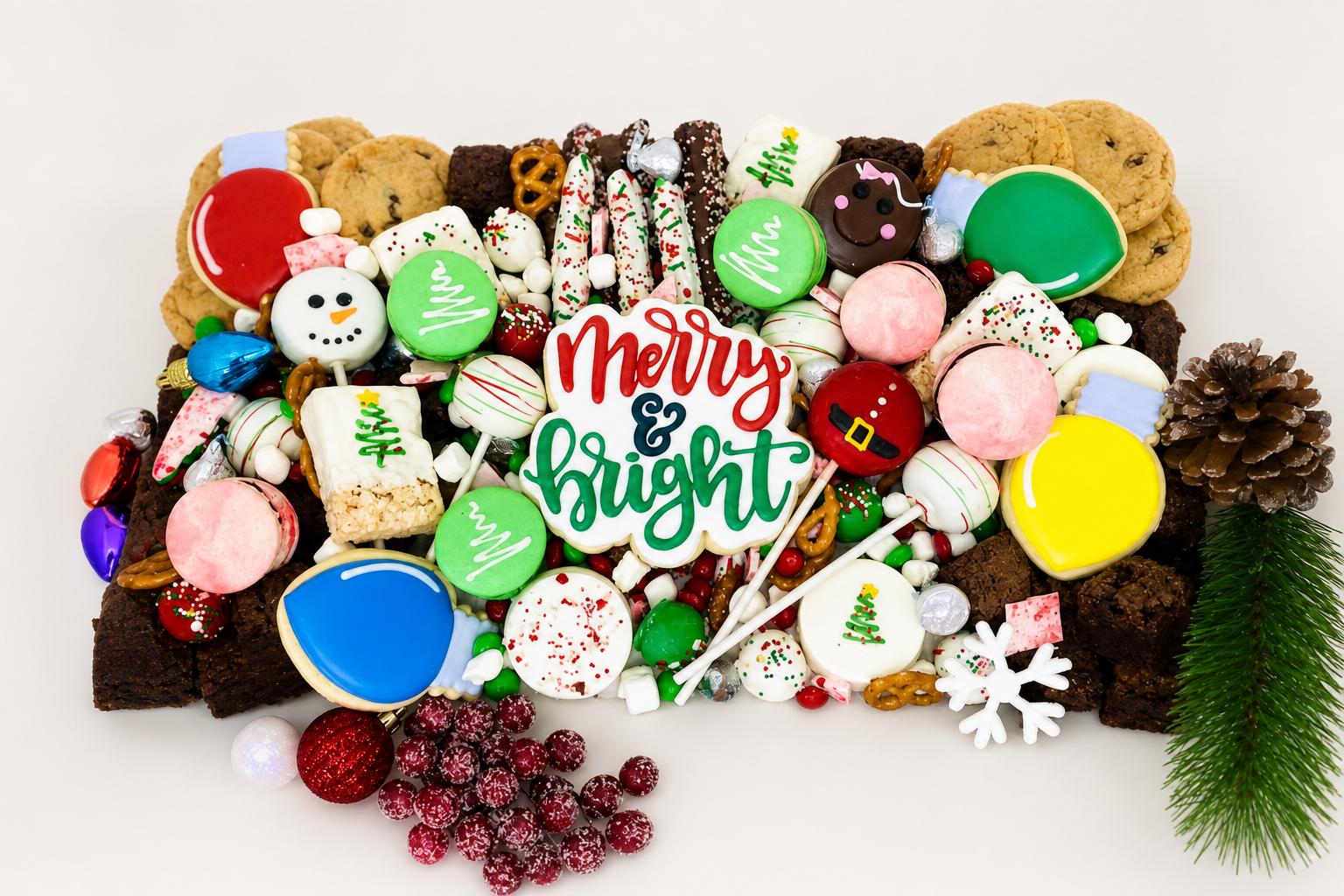 A Christmas dessert bar with festive decorated cookies, macarons, and holiday treats from Sweet Escape Cake Company in Indianapolis.