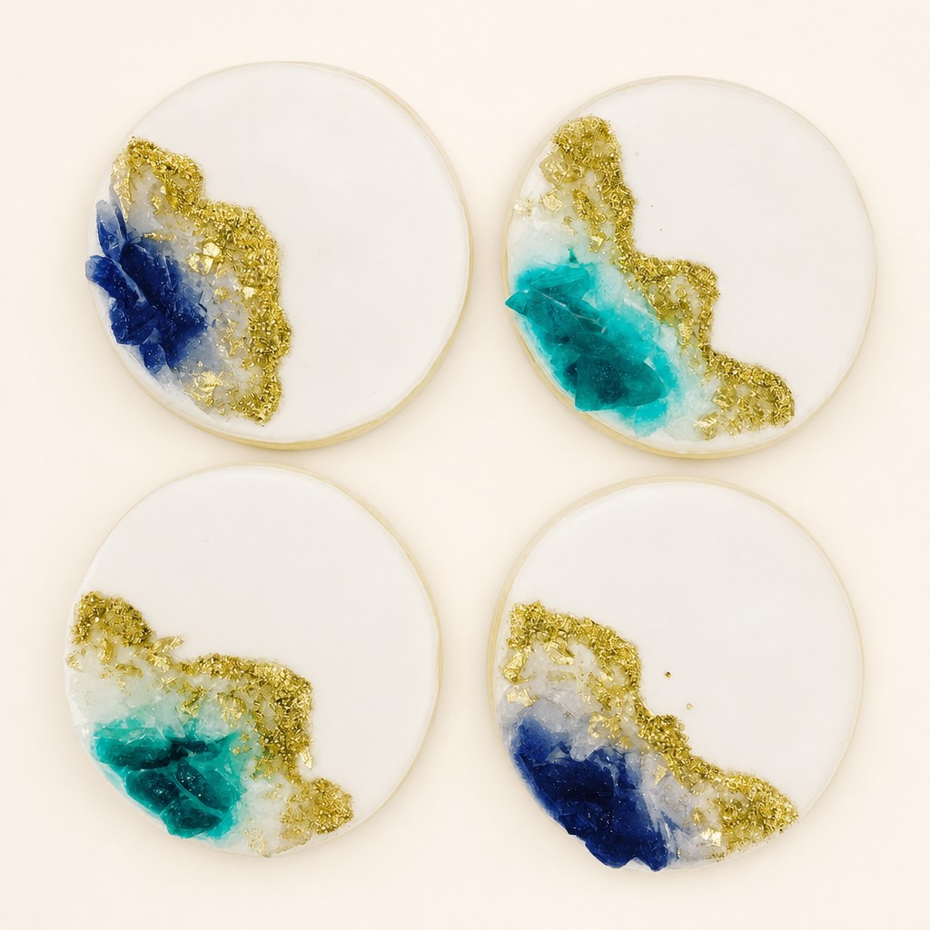 Royal iced geode wedding cookies in teal and gold for a dessert table by Sweet Escape Cake Company.