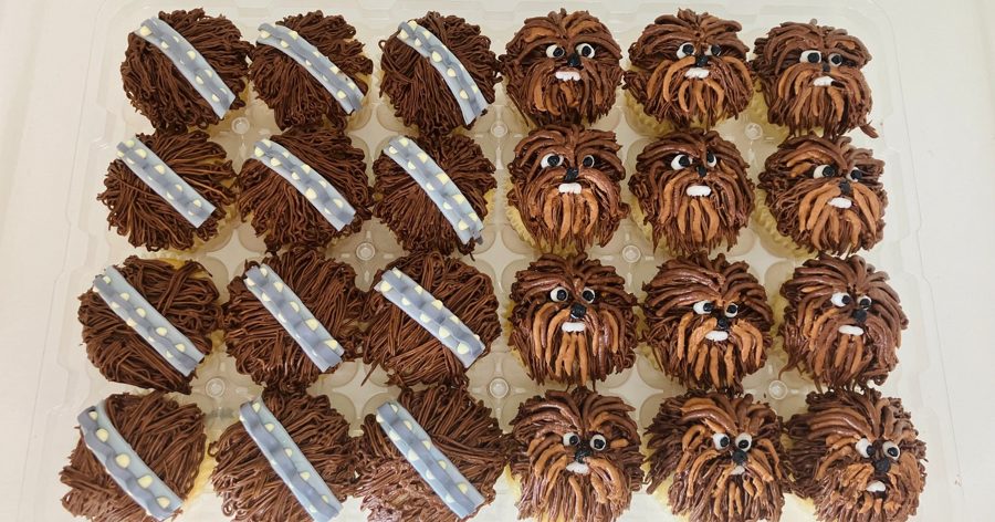 A collection of Star Wars Chewbacca-themed cupcakes, adorned with intricate brown piped buttercream fur, edible eyes, and some featuring gra