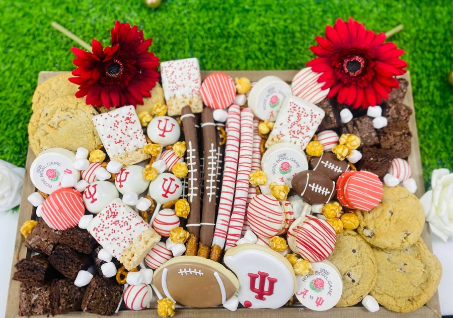 A vibrant football-themed dessert bar featuring decorated cookies, brownies, chocolate-covered pretzels, rice krispie treats, and cake pops,